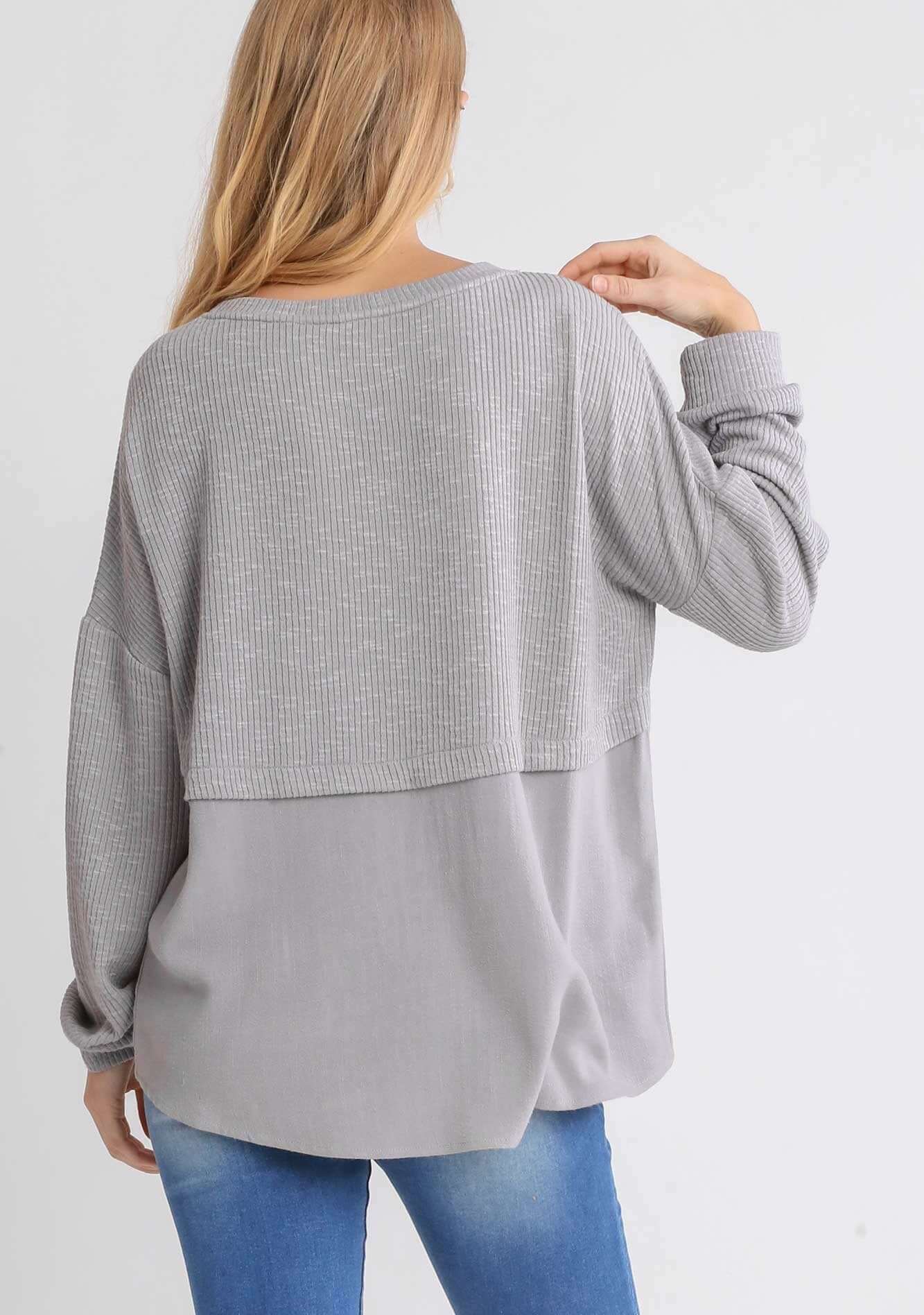 Woman wearing UMGEE Free and Easy Top in Cool Gray, showcasing the loose fit and contrast linen back detail.