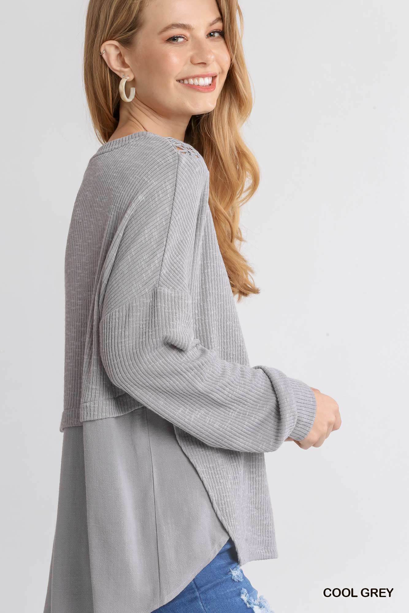 Woman wearing UMGEE Free and Easy Top in cool gray with crochet yoke and long sleeves, side profile view.