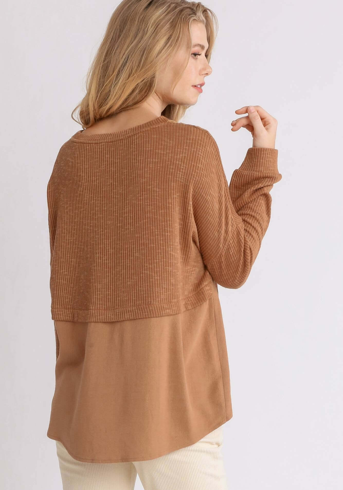 Woman wearing long-sleeve cinnamon top with crochet yoke and contrast linen back, showcasing the stylish Free and Easy design by UMGEE.