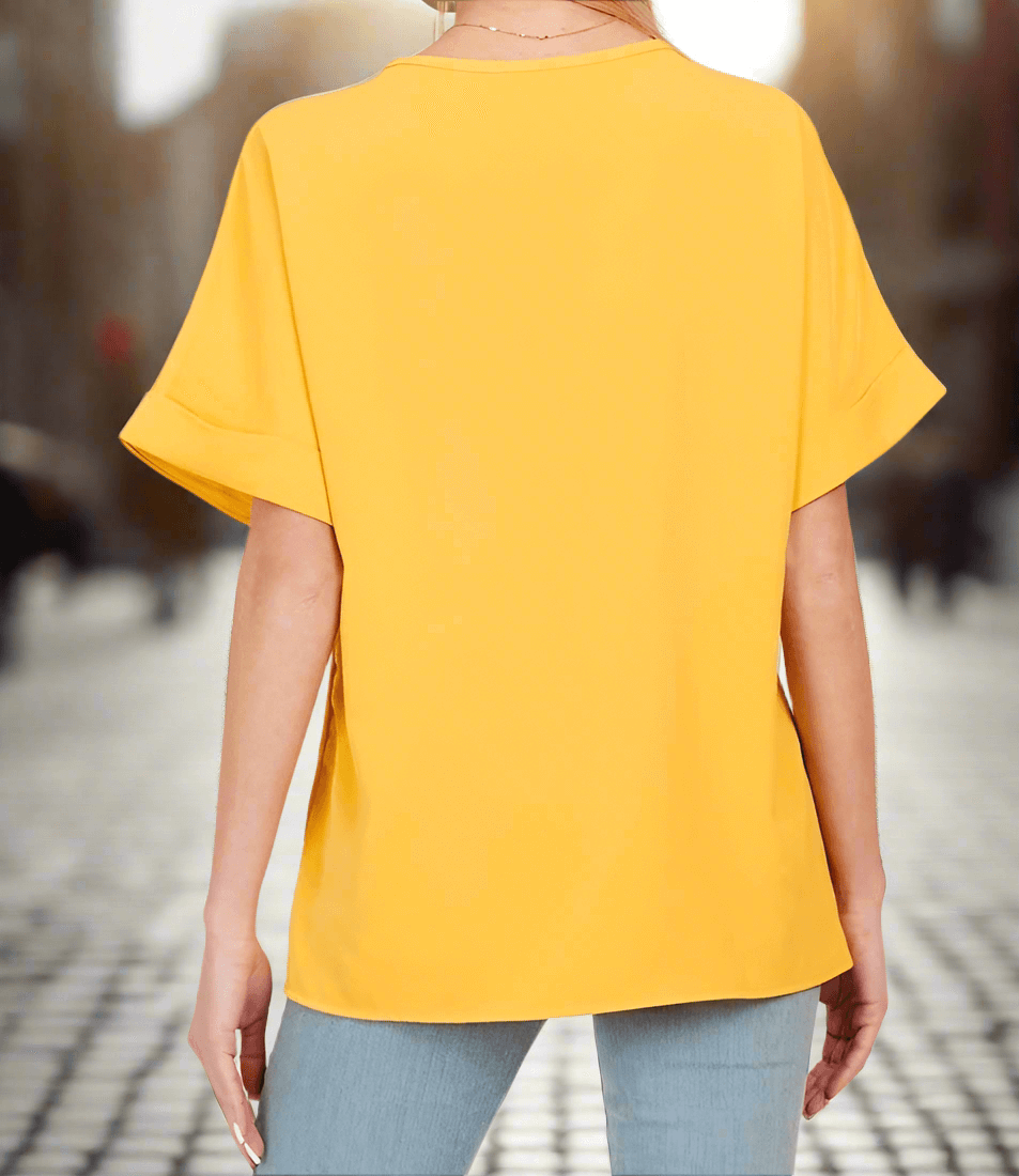 Back view of the MORNING HONEY Top in vibrant yellow, showcasing relaxed short sleeves and a modern silhouette.