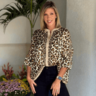 Model wearing the UNTAMED ELEGANCE top featuring a leopard print design and relaxed fit, perfect for effortless style.