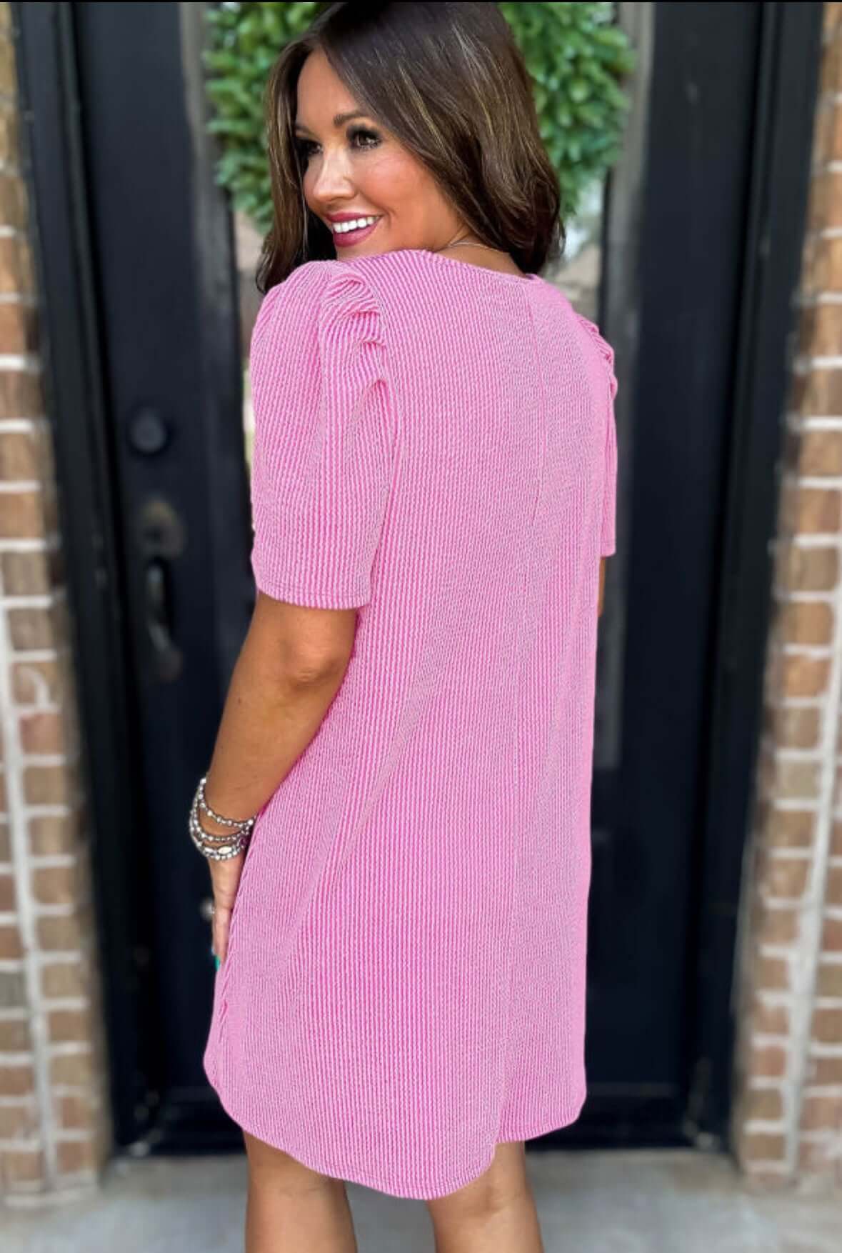 Back view of the Carefree Spirit Dress in rose pink, featuring short puff sleeves and a relaxed fit.