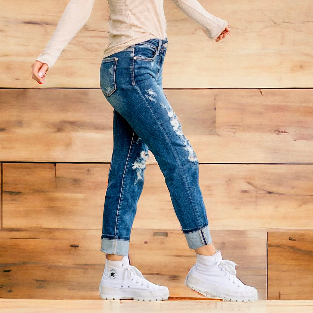 Model wearing JUDY BLUE ZOE Boyfriend Jeans in dark wash, showcasing cuffed style and distressed details.