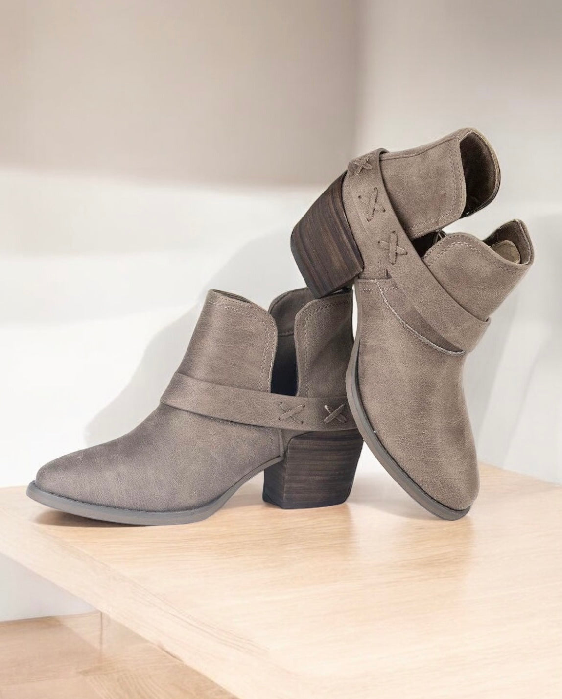 DIXIE ANN by: Very G by Very G $36.00 Cute kicks with a country feel - this DIXIE ANN bootie in Taupe is a winning lasso of style! Leather look ankle boots, sporting an almond shaped toe, ankle cut out, western strap with stitch detail held together by a