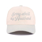 SORRY ABOUT MY HUSBAND HAT (6 colors) in cream color with embroidered text for a fun and cheeky statement.