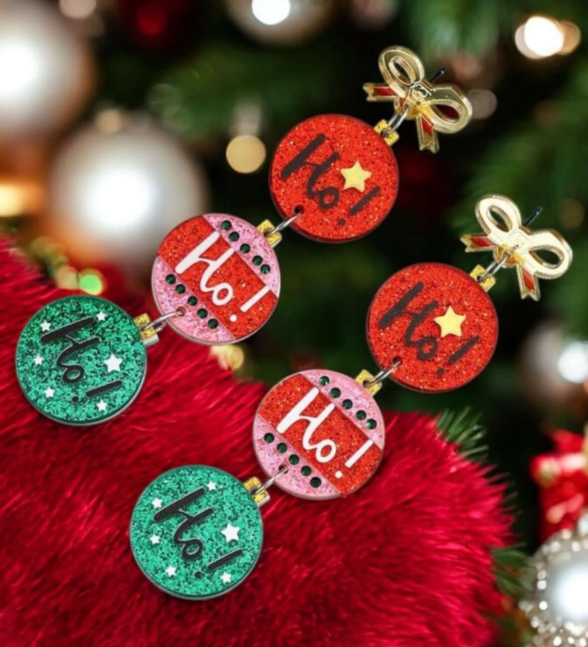 Festive HO HO HO earrings with gold-tone bows and colorful Christmas balls, perfect for holiday celebrations.