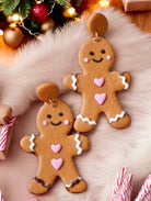 Gingerbread couple earrings featuring cheerful gingerbread man and woman designs, perfect for festive holiday wear.