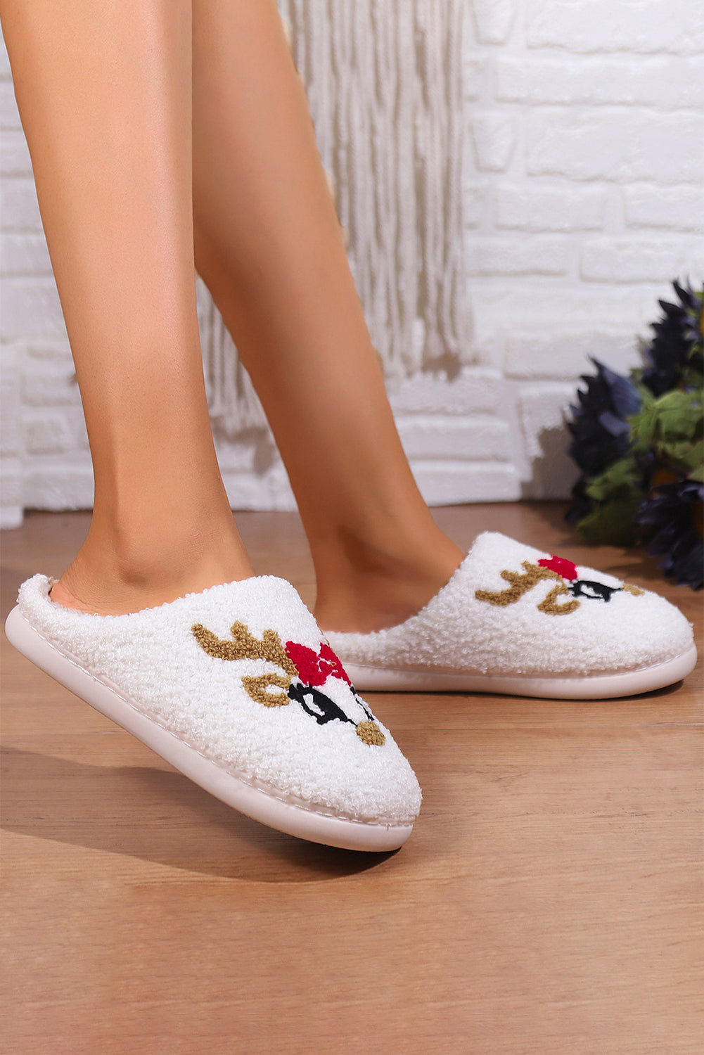 Cozy reindeer-themed slippers featuring a cute Cupid design, perfect for the holiday season, worn indoors for warmth and comfort.