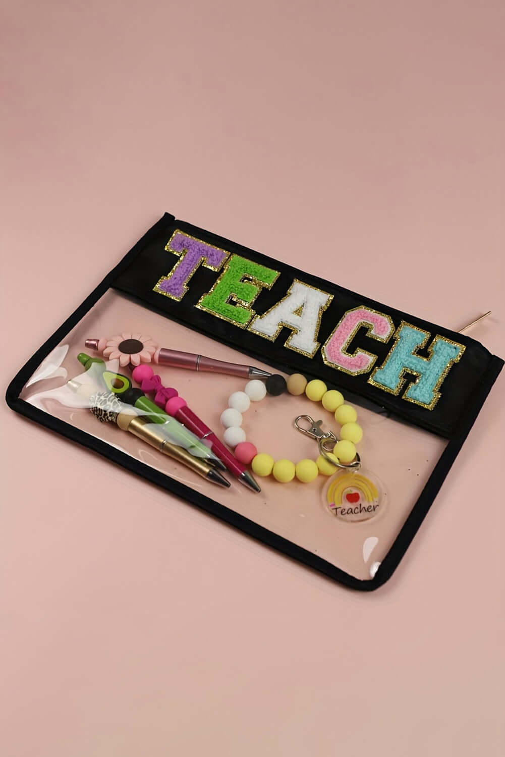 In My Teacher Era bag with glittery TEACH letters and colorful stationery inside, perfect for organized teaching essentials.
