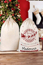 Festive Jumbo Santa bags featuring "Northpole Express" design, perfect for holiday gift storage by the Christmas tree.