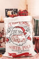 Jumbo Santa bag with festive design, "Dear Santa" and "North Pole" delivery services, filled with colorful holiday gifts.