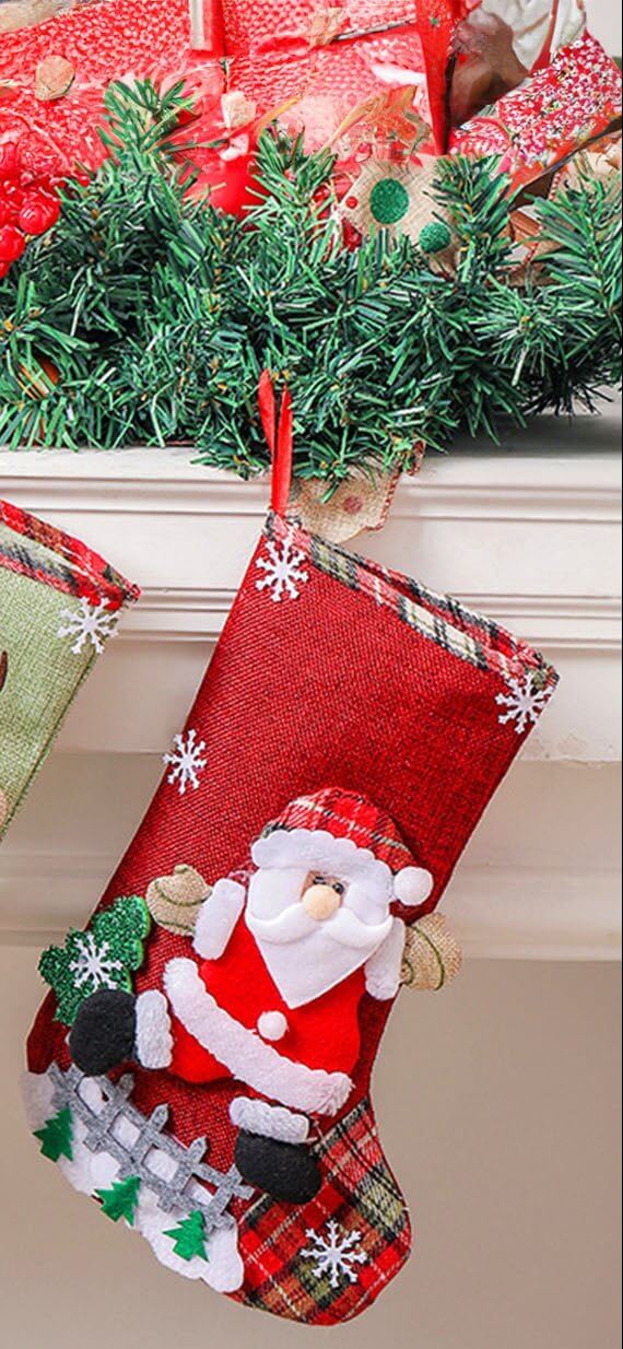 Santa's stocking filled with gifts, featuring red burlap, plaid details, and festive felt applique, hanging by the fireplace.