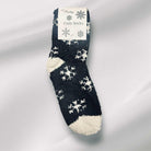 WINTER SNOWFLAKE Sherpa Socks in black with white snowflake pattern, perfect for winter coziness and style.