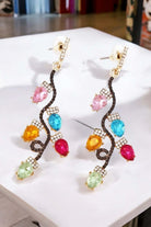 Colorful Christmas light show earrings with rhinestone gems in gold tone, perfect for festive holiday outfits.