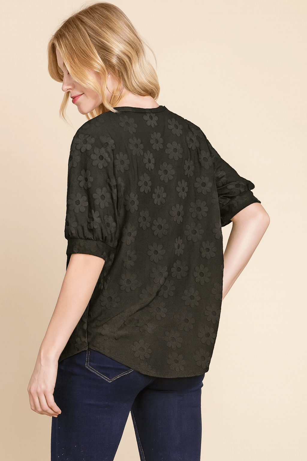 Back view of the black Field of Daisies Top with textured daisy embroidery on a model.