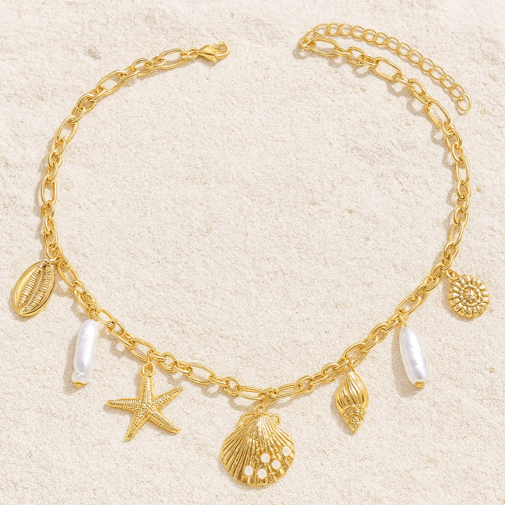 High Tide Treasures charm necklace with golden seashells, starfish, and pearl beads on a chic gold tone chain.