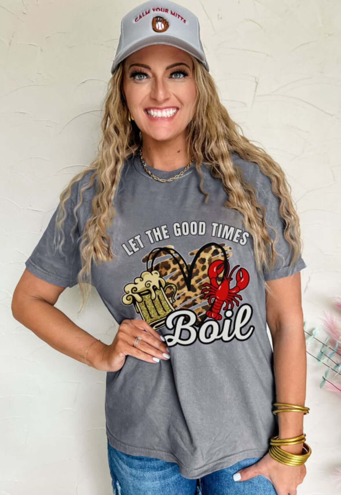 Model wearing 'Let the Good Times Boil' graphic tee featuring crawfish and beer mugs.