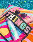 THINGS CASE by Teal Tiger Boutique $15.00 Introducing the THINGS CASE a stylish and practical accessory for all your travel needs. This super cute bag is trimmed in black and features a “Things” Chennille patch, making it the perfect companion for all of