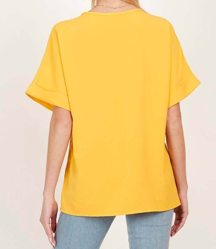 Back view of the Morning Honey Top in bright yellow, showcasing its relaxed fit and short sleeves.
