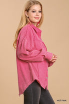 Model wearing a hot pink mineral wash button-down top with high-low hem from Umgee for casual style.