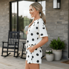 Model wearing MOMENT IN TIME - 2 PIECE SHORTS SET featuring black and white polka dots, perfect for summer style.