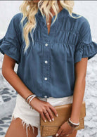 Stylish Cloud Chaser Top in blue with ruffled sleeves, perfect for casual summer outfits.