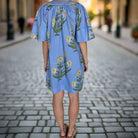 Back view of Blue Sky Beauty Dress, featuring floral embroidery and breezy bell sleeves.