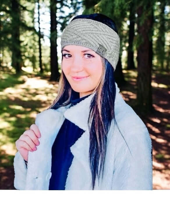 Model wearing C.C. Riley CrissCross Head Wrap in a forest setting, showcasing warmth and style.