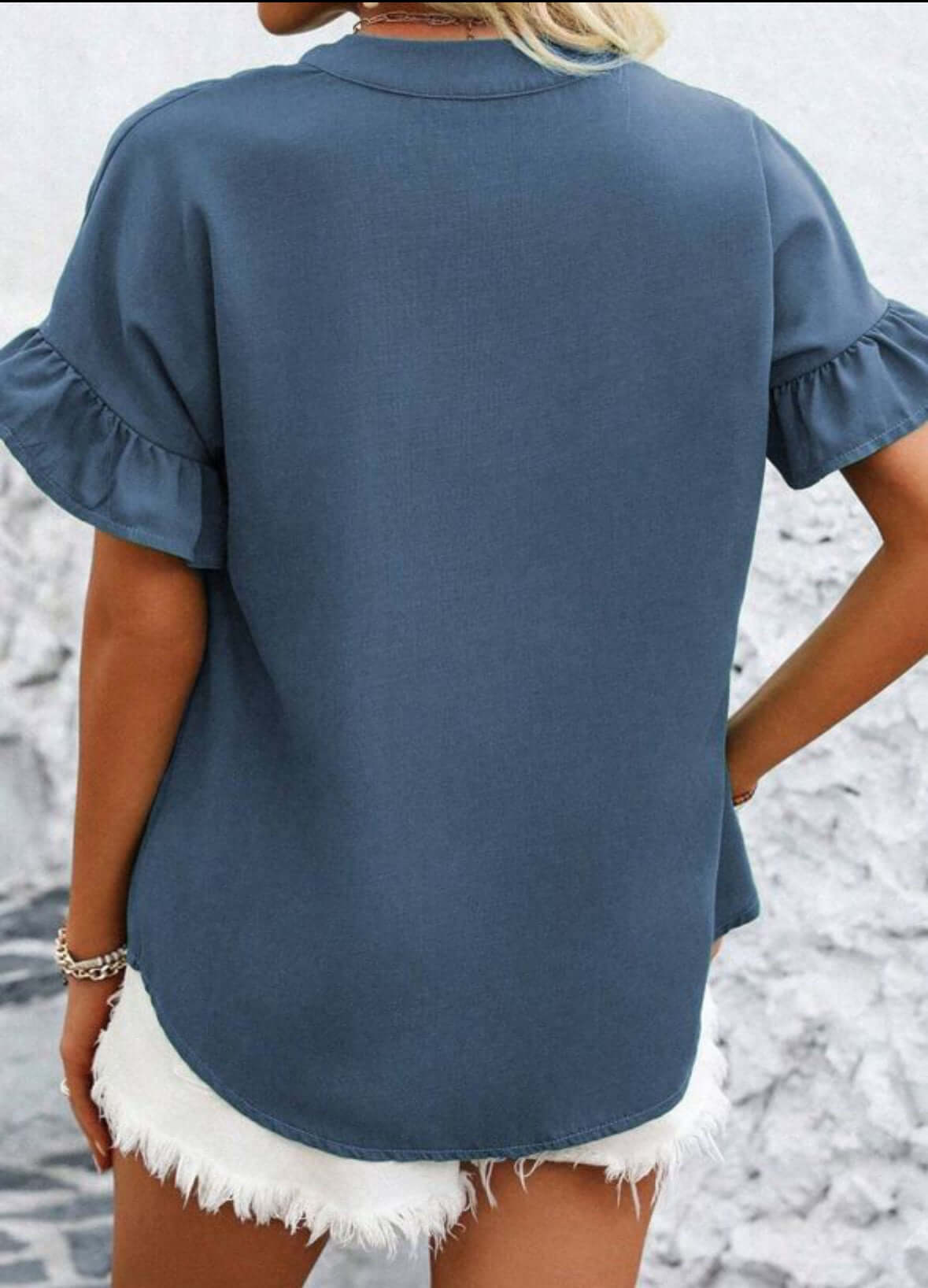 CLOUD CHASER TOP in navy blue, featuring ruffled sleeves and a relaxed fit, styled with white shorts.