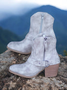 MERLOT LOW BOOTIES IN Cream by: VERY G by Very G $69.00 Cowgirl up any outfit with these ultra-cute Merlot Low Booties by Very G in Cream Gray! Boasting a leather-look, an almond-shaped toe, and a cool western-style strap fastened with a silver ring, thes