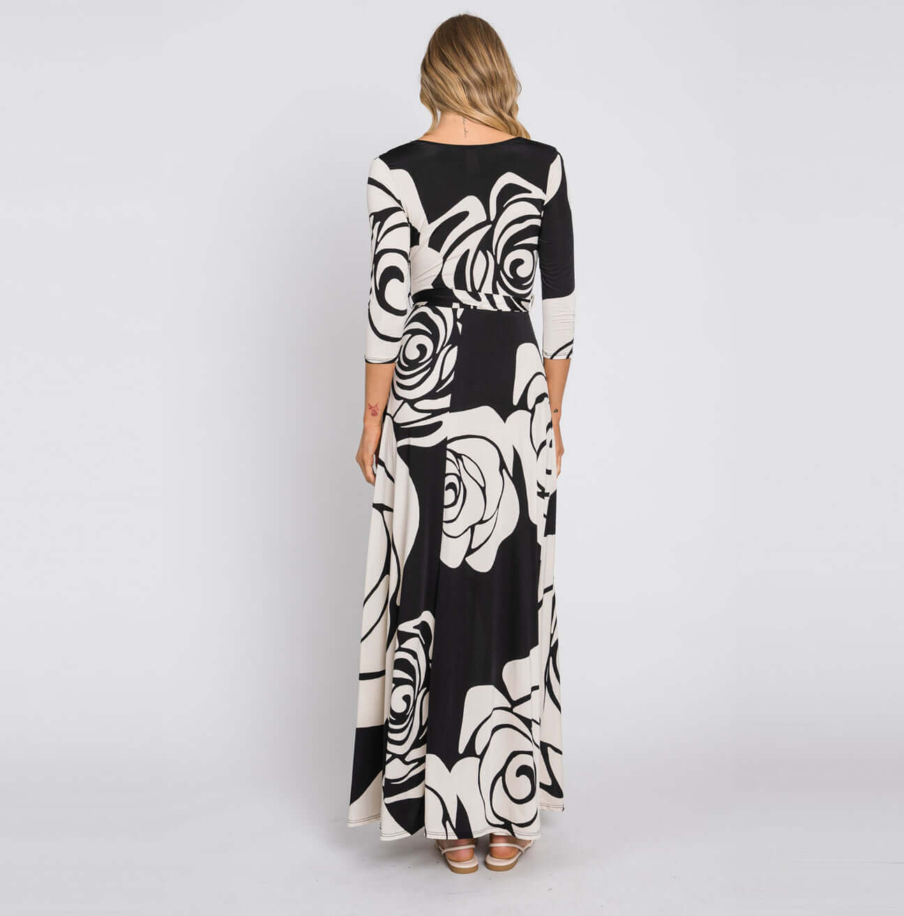 Back view of the Midnight Rose Maxi Wrap Dress with black and white floral design and 3/4 sleeves.