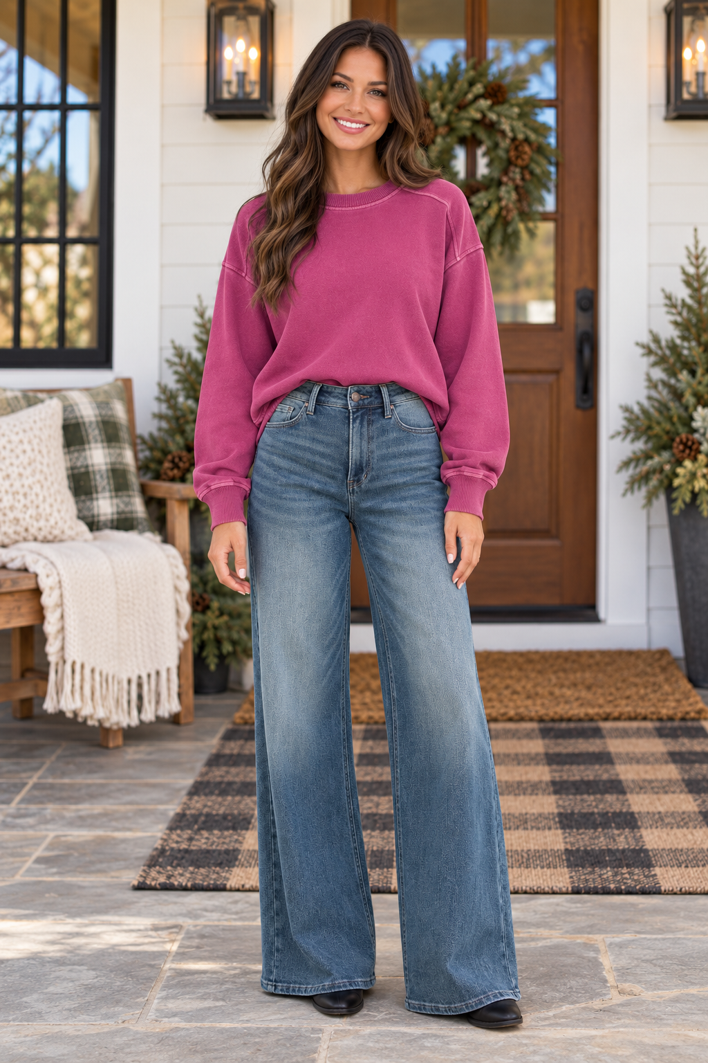 Model showcasing JUDY BLUE - LIZA high-waisted palazzo jeans with a pink sweatshirt outdoors.