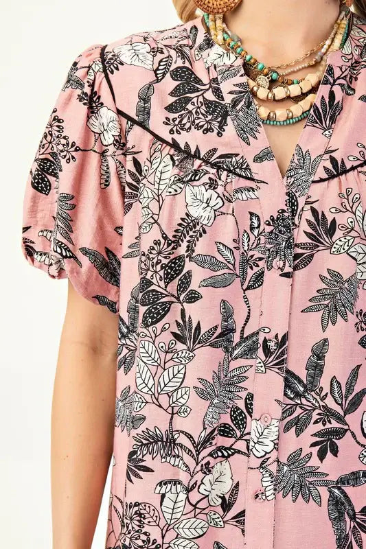 Close-up of the Love To Be Me Dress featuring a floral print on a soft pink background and stylish puff sleeves.