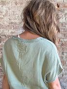 GULF BREEZES TOP - Stylish Sage Blouse | La Miel by La Miel $38.00 Stay comfy and trendy this autumn with the GULF BREEZES TOP. Perfect for lounging, this boutique blouse features raw edges, a V-neck, and a high-low hem. Teal Tiger Boutique