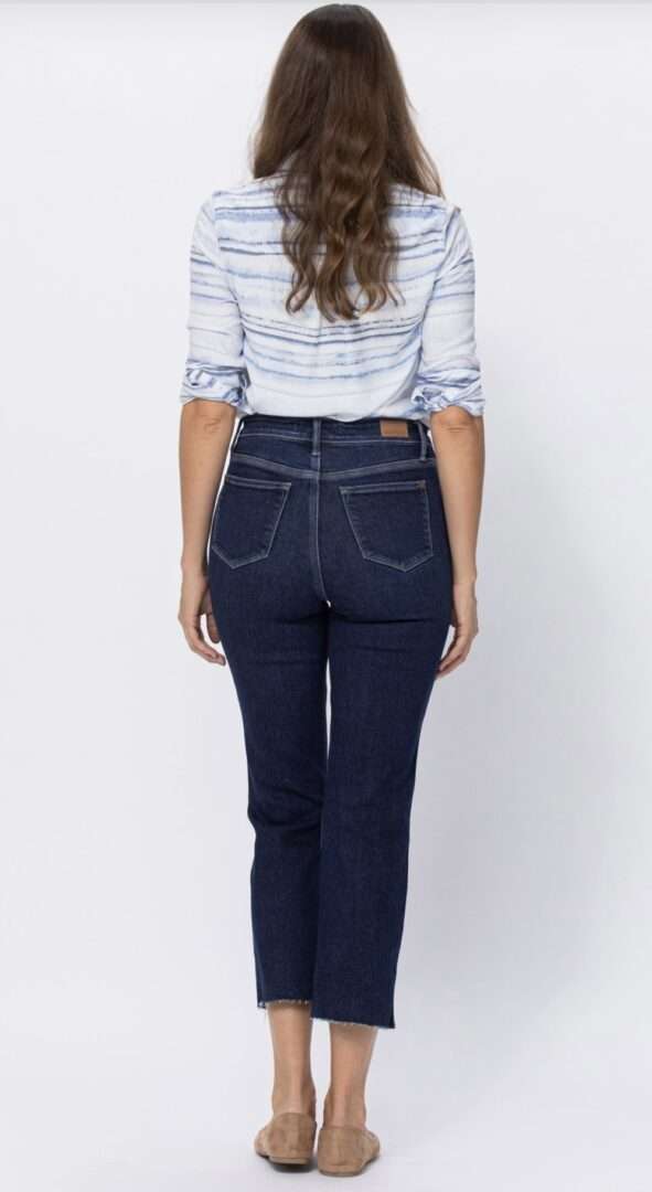 Back view of a woman wearing Judy Blue Joannie high-waisted dark wash jeans, styled with a striped shirt.