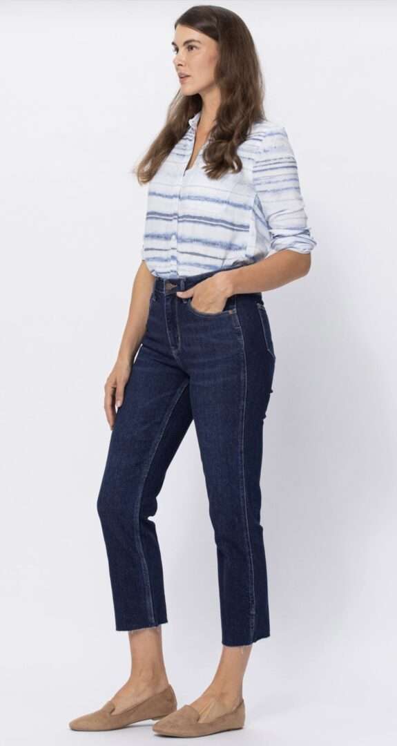 Woman wearing high-waisted Judy Blue Joannie jeans in dark wash with a cropped straight fit.