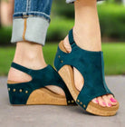 Teal faux suede wedge sandals by Corkys, featuring a stylish design and comfort foam lining, perfect for all occasions.