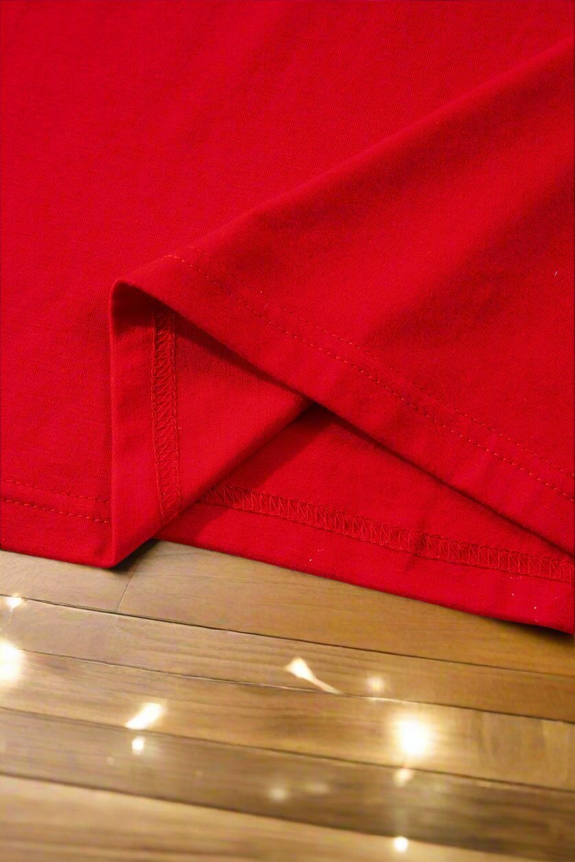 Close-up of vibrant red fabric of SWEET DREAMS CANDY CANE Pajamas, showcasing soft and comfortable material perfect for holiday relaxation.