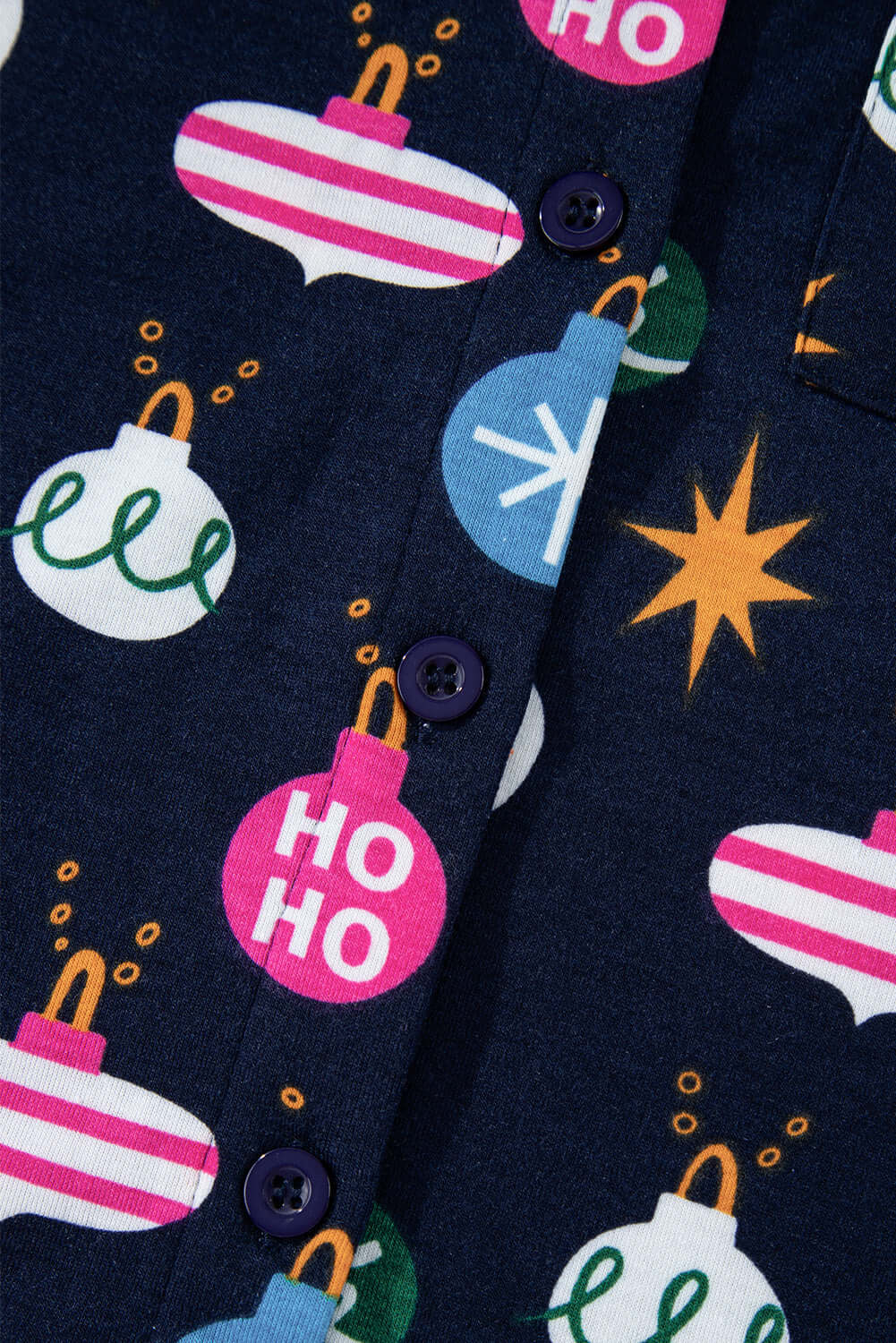 Festive design details on BLUE CHRISTMAS WITHOUT YOU PJ's with holiday ornaments and snowflakes, featuring a button-up front.