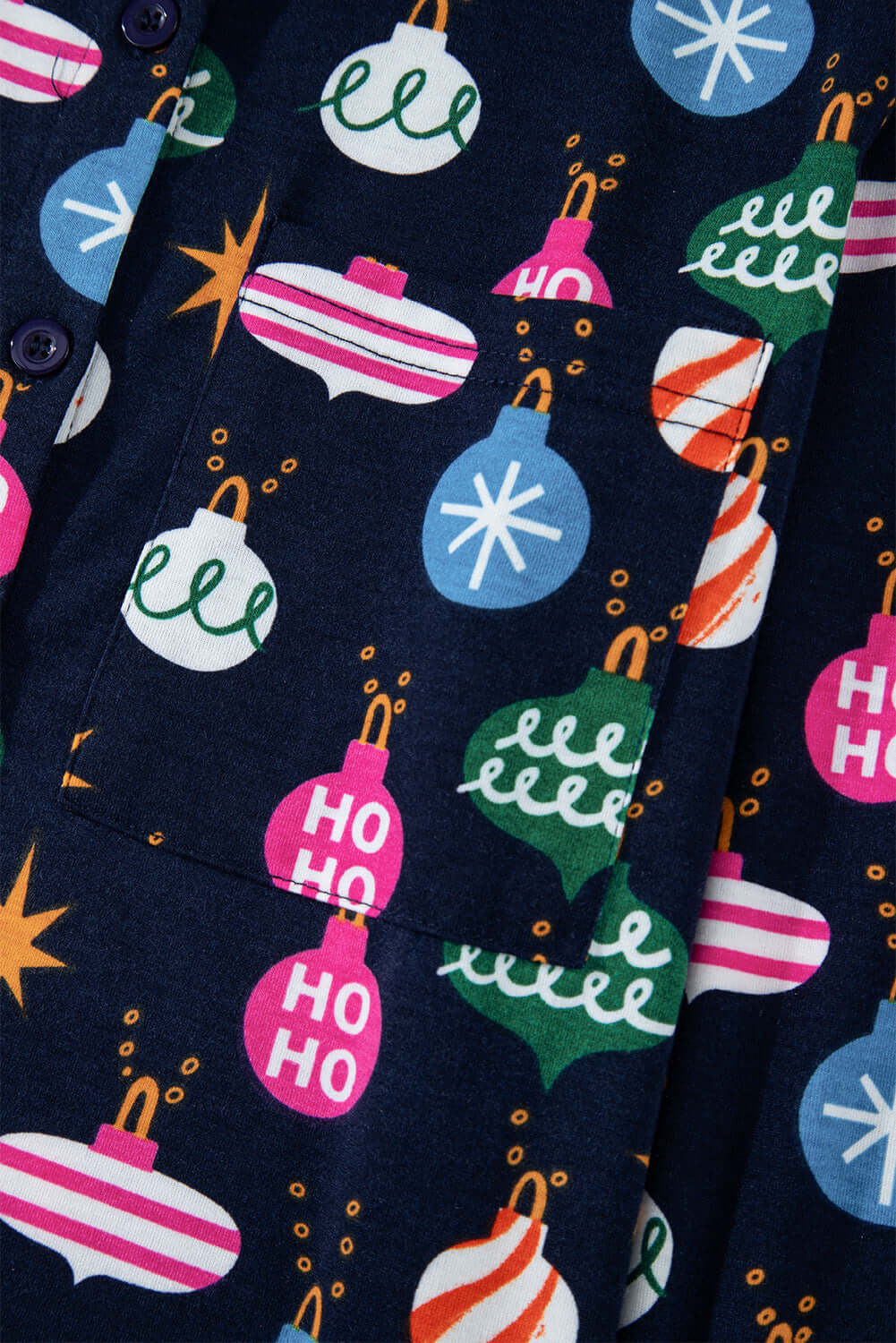 Festive Christmas-themed pajama fabric with colorful ornament designs on a dark background, featuring a playful pattern for holiday cheer.