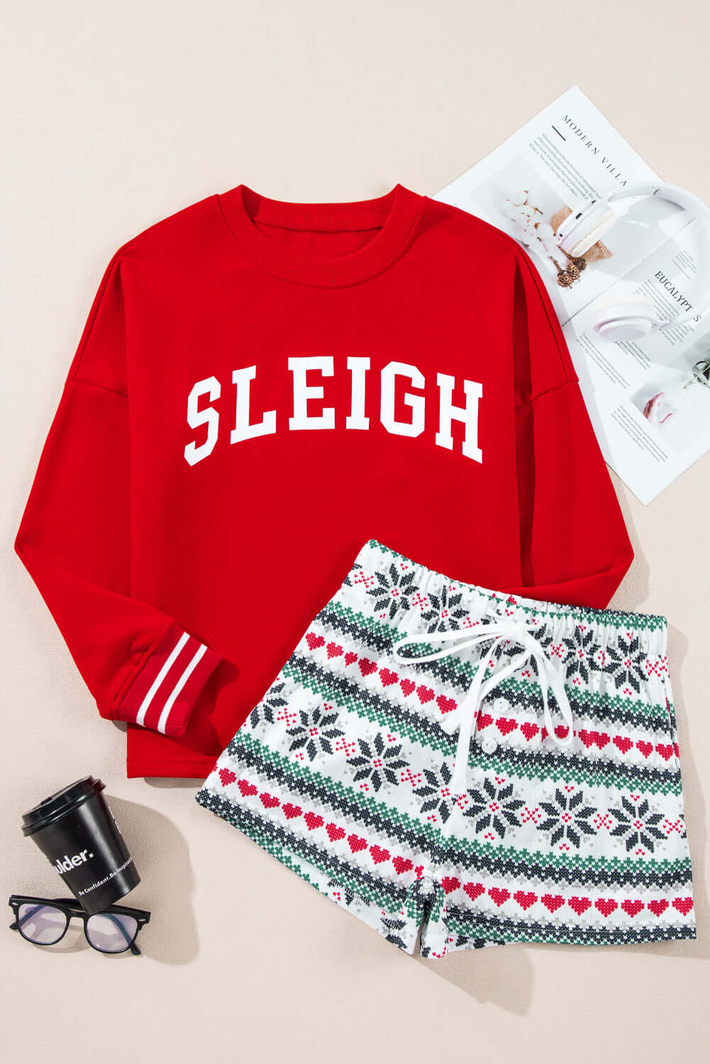 Red "Sleigh" long-sleeve pajama set with snowflake print shorts, featuring drawstring waist and cozy fleece lining, perfect for Christmas lounging.