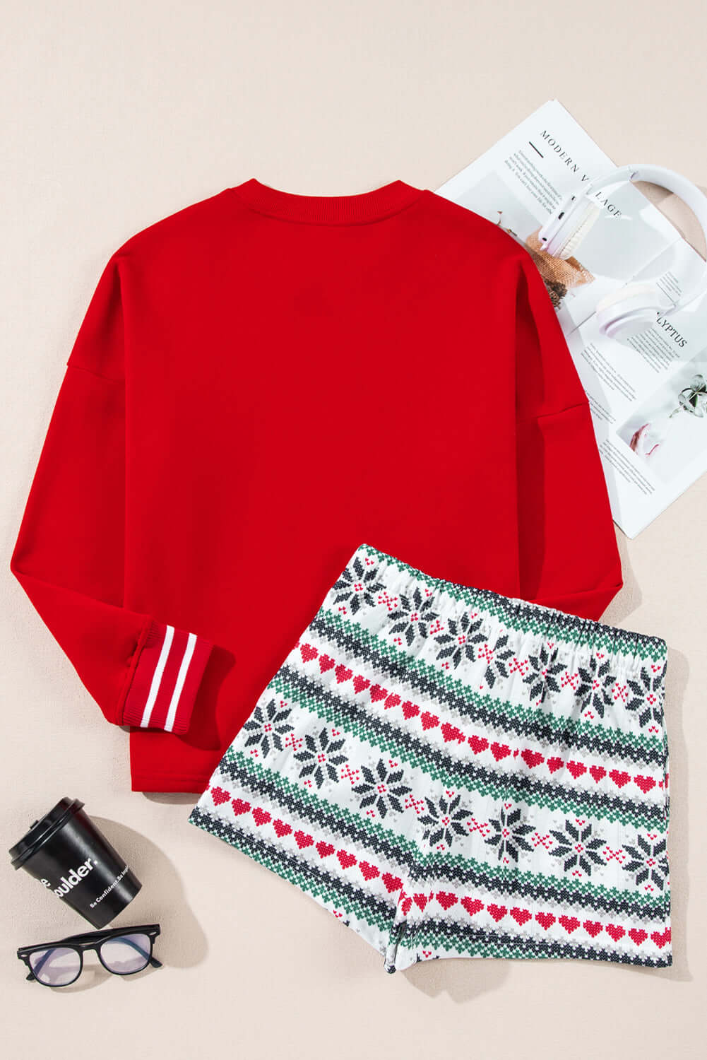 Festive red and white Christmas pajama set with snowflake print shorts, featuring a cozy fleece-lined top and drawstring shorts with pockets.