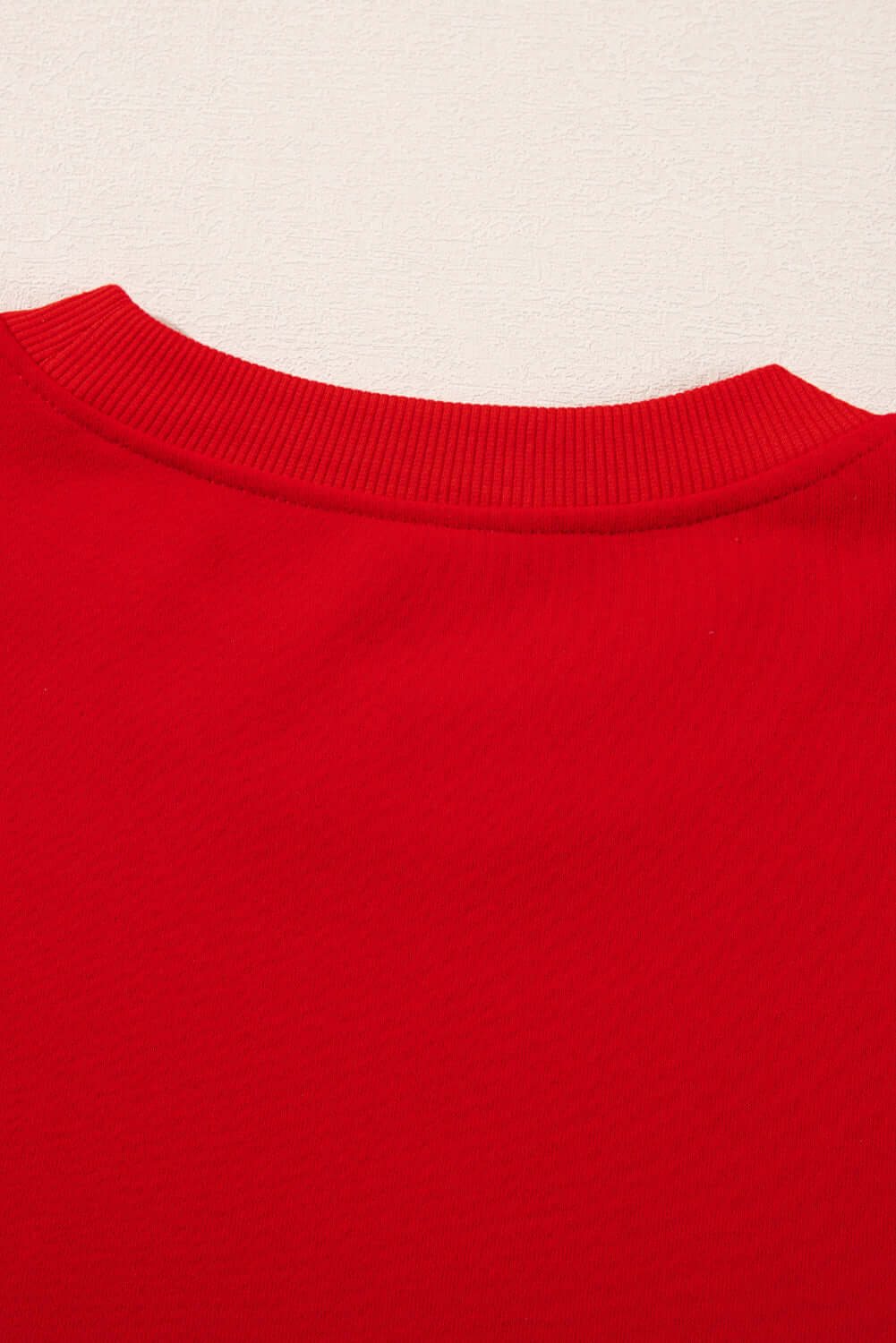 Close-up of red fleece-lined top from the SLEIGH GIRL SLEIGH PJ Set by Vivian-Lu, perfect for cozy holiday lounging.