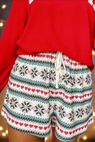 Festive holiday loungewear with snowflake print shorts and a red fleece top, perfect for cozy Christmas lounging.