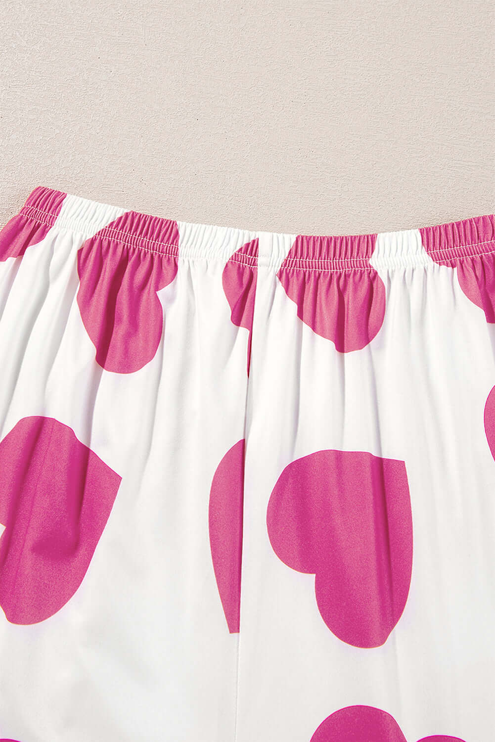 Heart-print lounge pants with pink hearts on a white background, part of the Love Language Lounge Set.