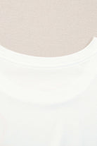 Close-up of a white ruffled tank top neckline designed for a feminine and relaxed fit.