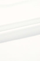 Close-up of soft, smooth white fabric, ideal for comfortable lounge wear and casual clothing.