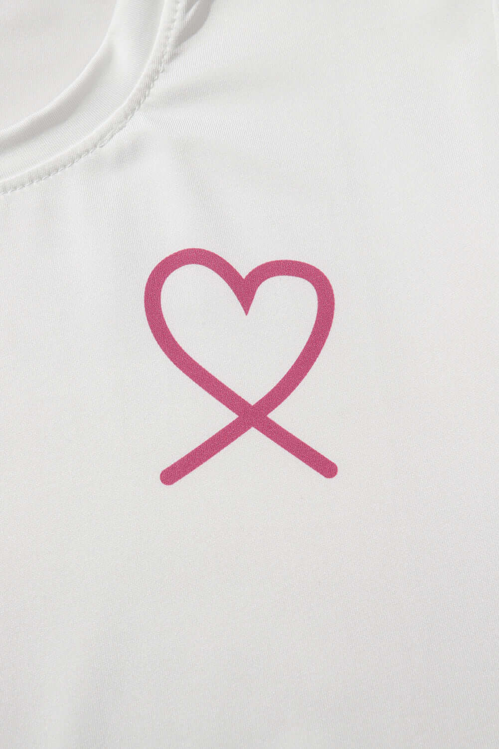 Pink heart graphic design on a white fabric, symbolizing love, from a cozy lounge set.
