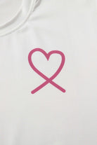 Pink heart graphic design on a white fabric, symbolizing love, from a cozy lounge set.