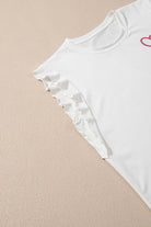 Ruffled white tank top from the Love Language Lounge Set, showcasing feminine details and a heart design.